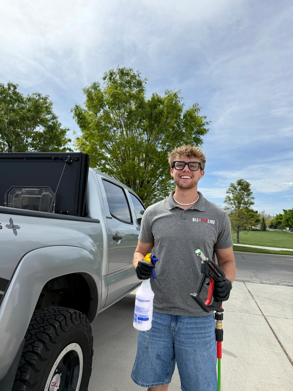 Caleb Allred, owner of All-Red Detailing, beside his detailing truck